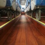 AU20-130-6 wood-design PVC flooring installed in a coach aisle