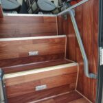 AU20-130-6 wood-design PVC flooring installed on coach entrance steps