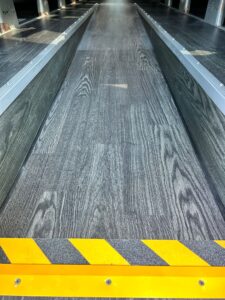 AU20-2816 black wood-grain PVC flooring in a U.S. customer vehicle project